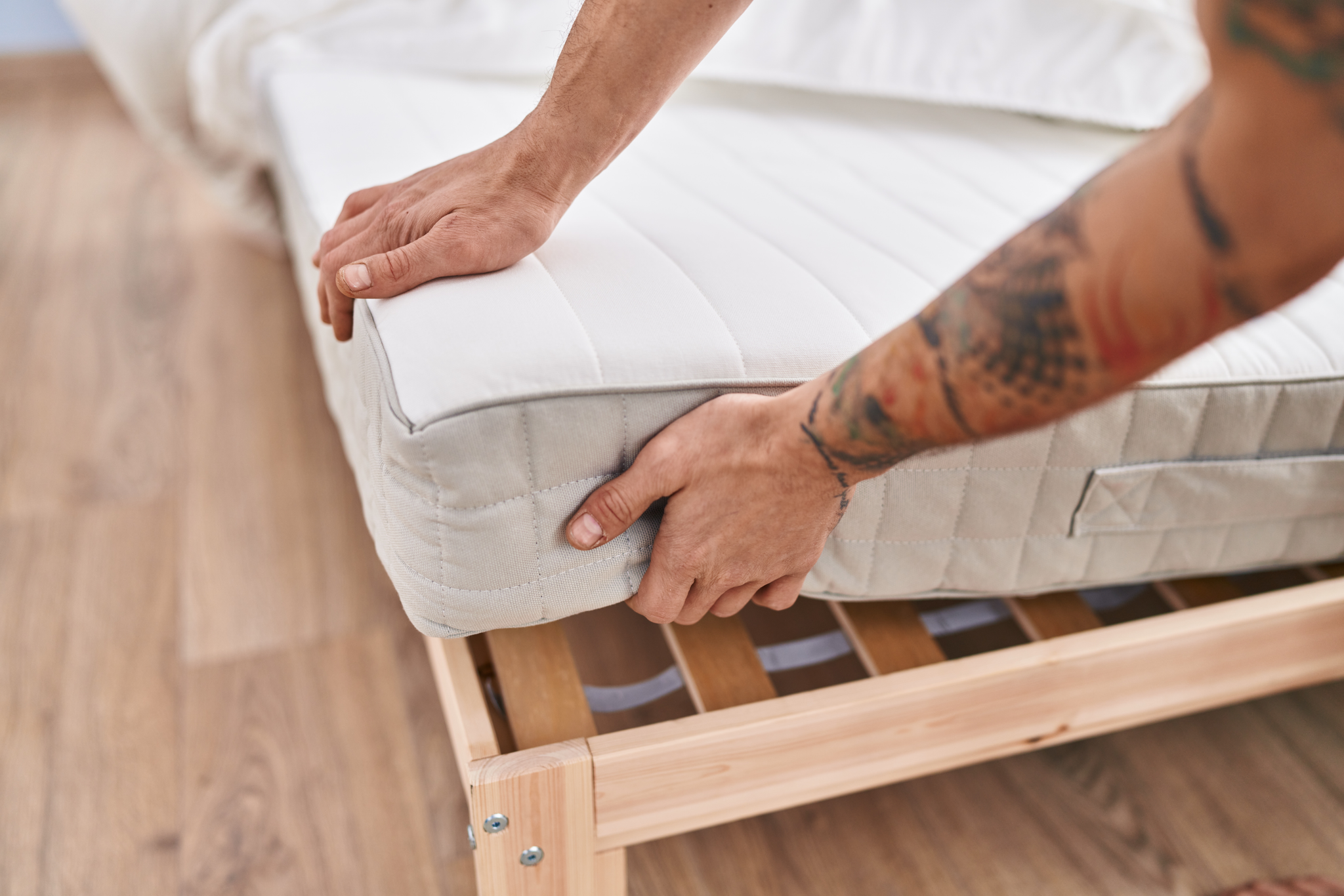 Man lifting mattress