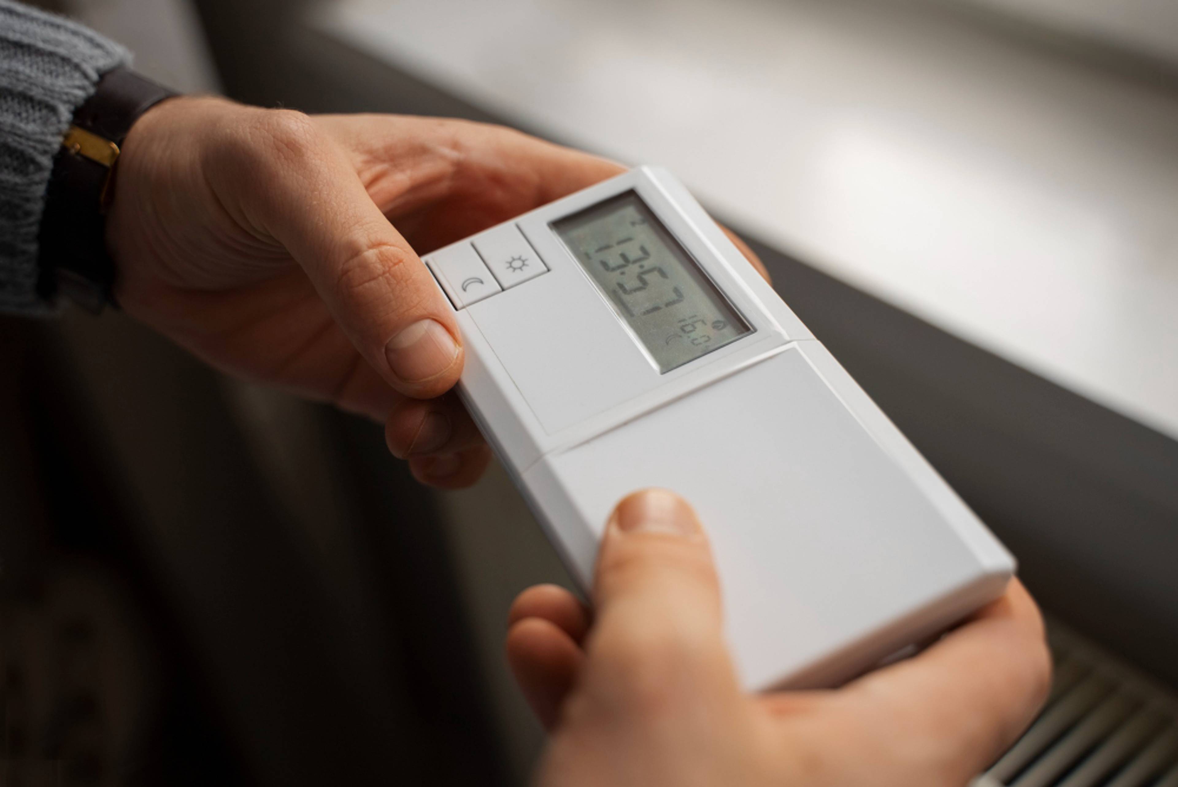 Man holding a climate control device