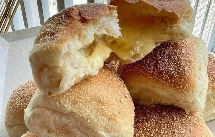 Soft Filipino pandesal buns with melty cheese filling.