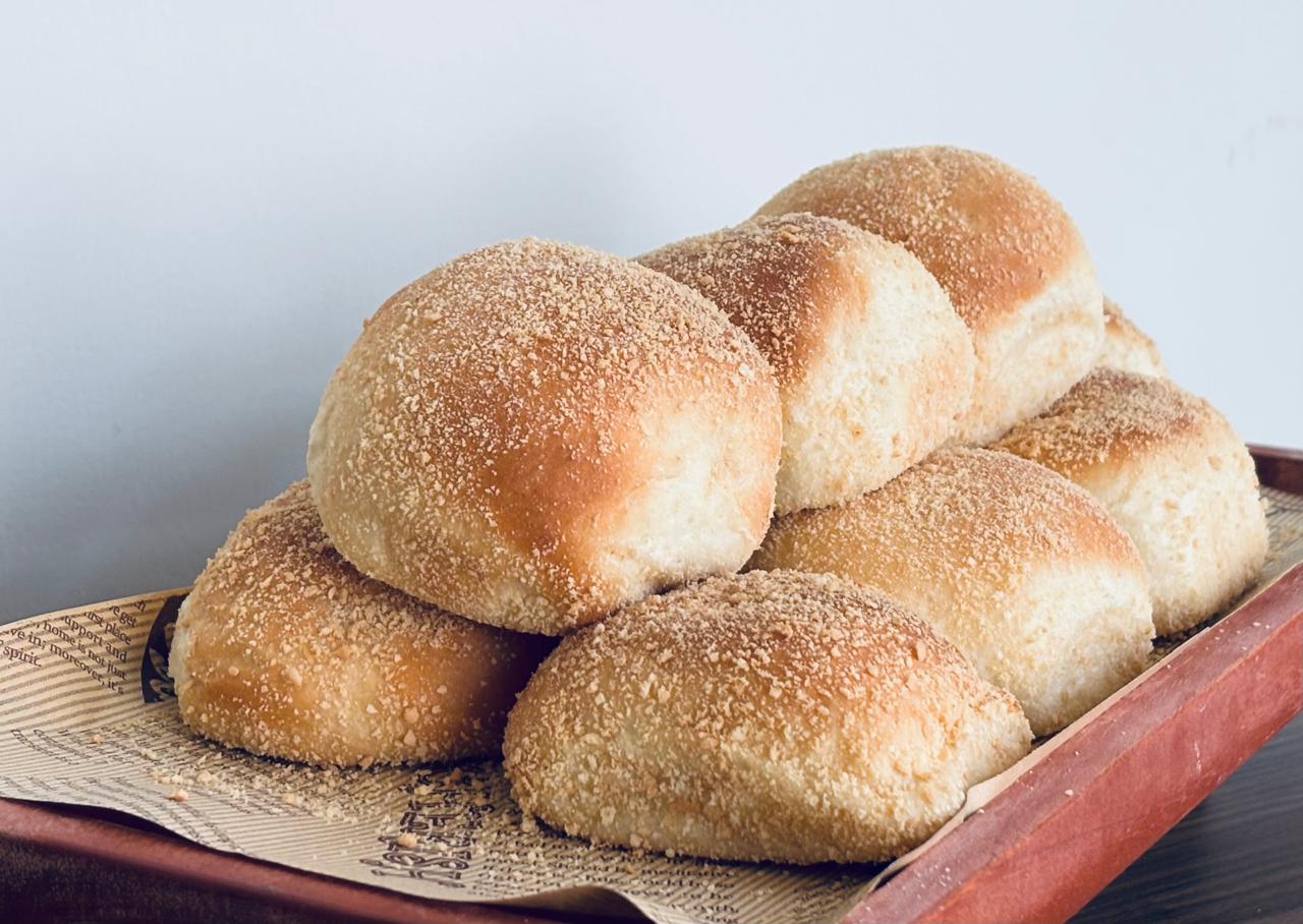 Soft and fluffy Filipino pandesal bread rolls with a slightly sweet taste.