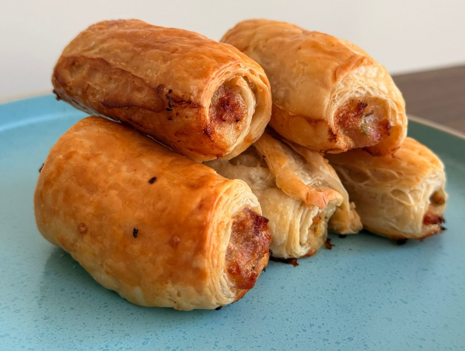 Golden puff pastry rolls filled with seasoned pork sausage.