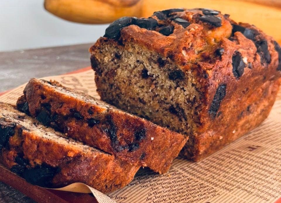 Moist banana cake loaf with scattered chocolate chips.