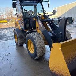 What is a telehandler telescopic handler lifting a pallet on a construction site