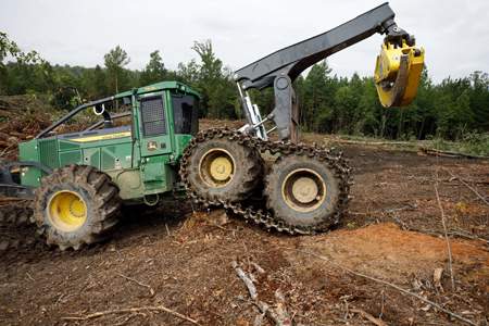 768L-II bogie skidder maneuvering over a stump
