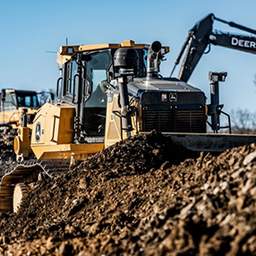 What is a telehandler telescopic handler lifting a pallet on a construction site