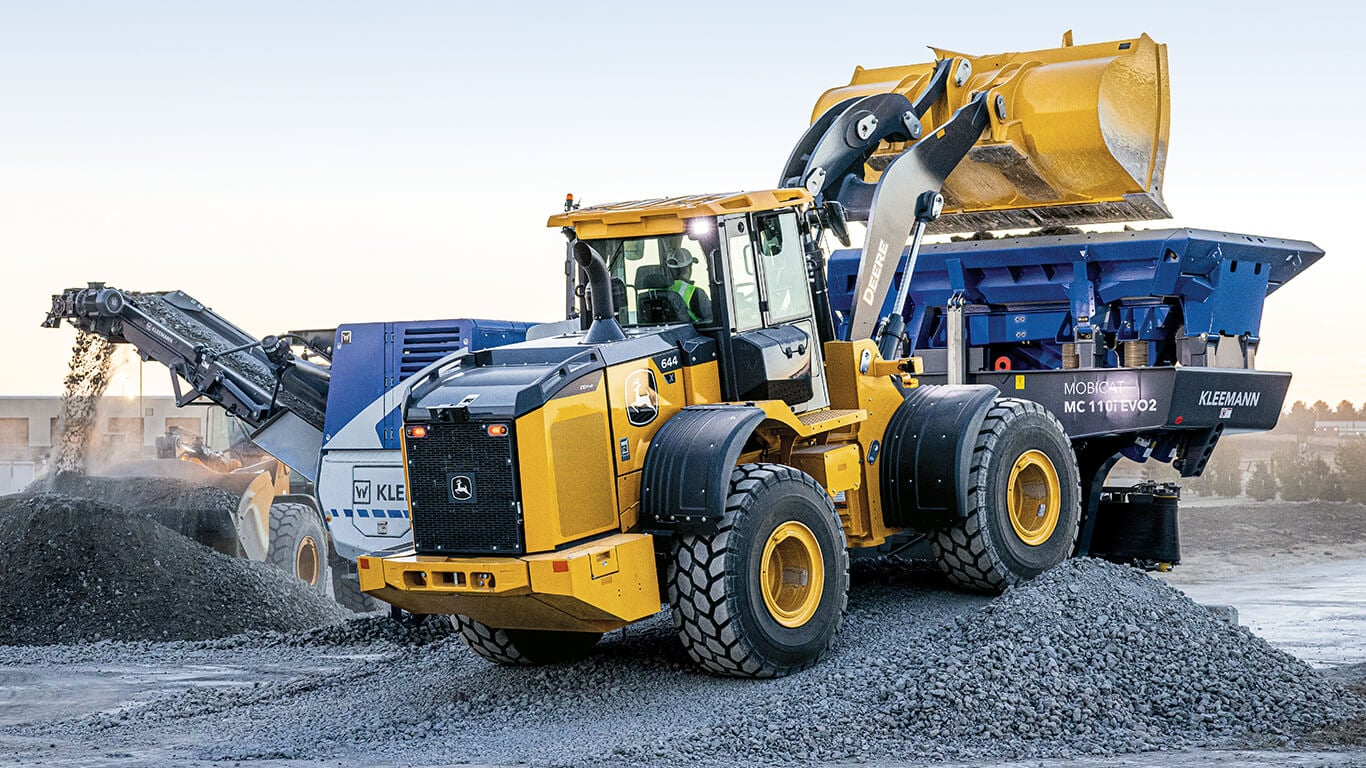 wheel loader moving gravel during highway construction operations