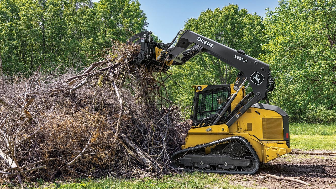 Skid steer forestry mulcher clearing brush