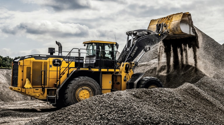 hydraulic excavator performing rock extraction at quarry mining site