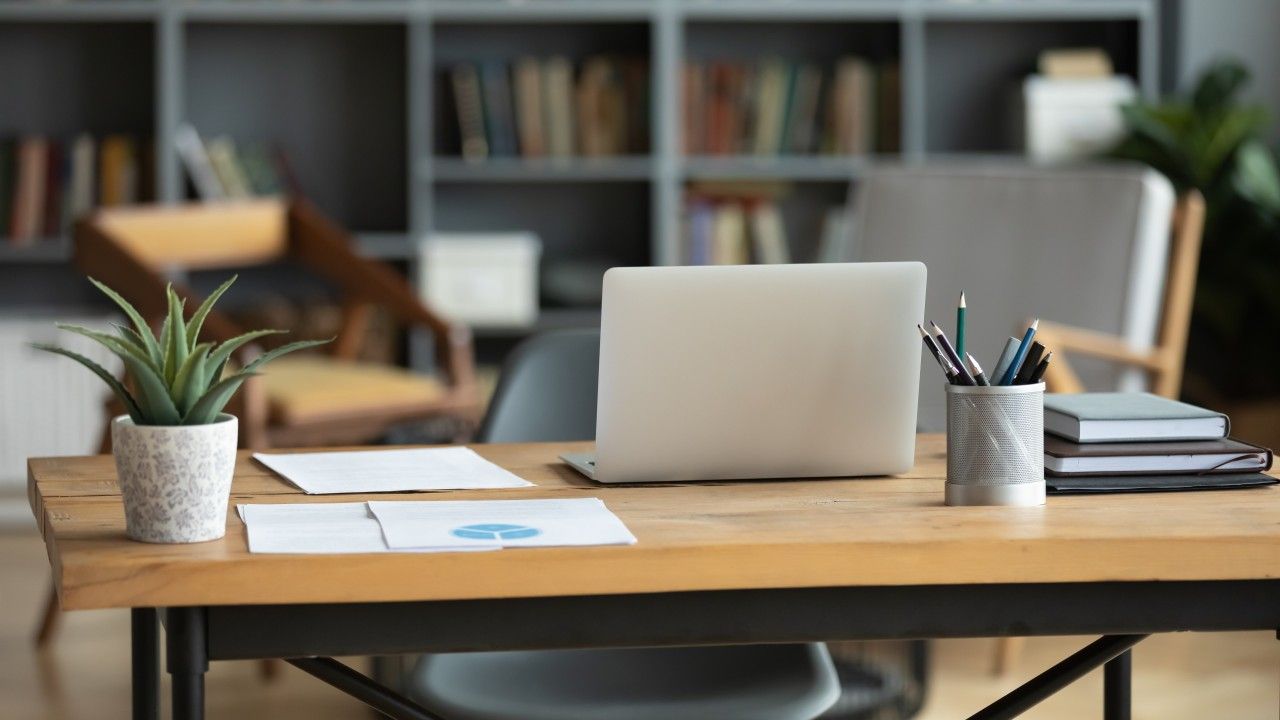 Executive workspace with laptop and documents, representing strategic planning