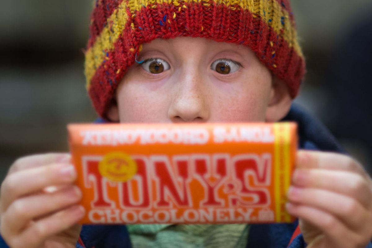 Child holding a Tony’s Chocolonely chocolate bar