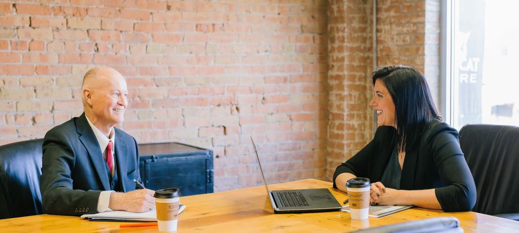 Two people having a business discussion at a table
