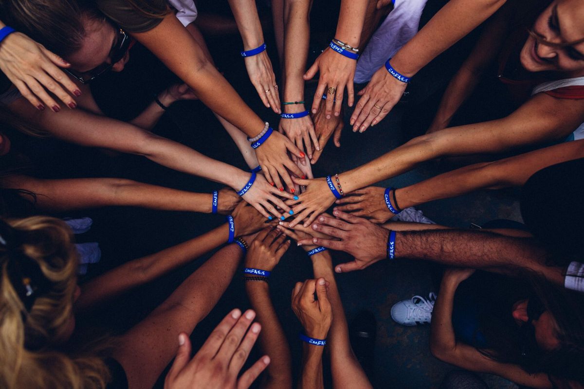 People stacking hands