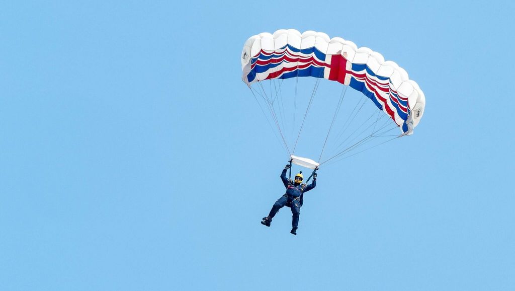 Person parachuting with a Union Jack flag