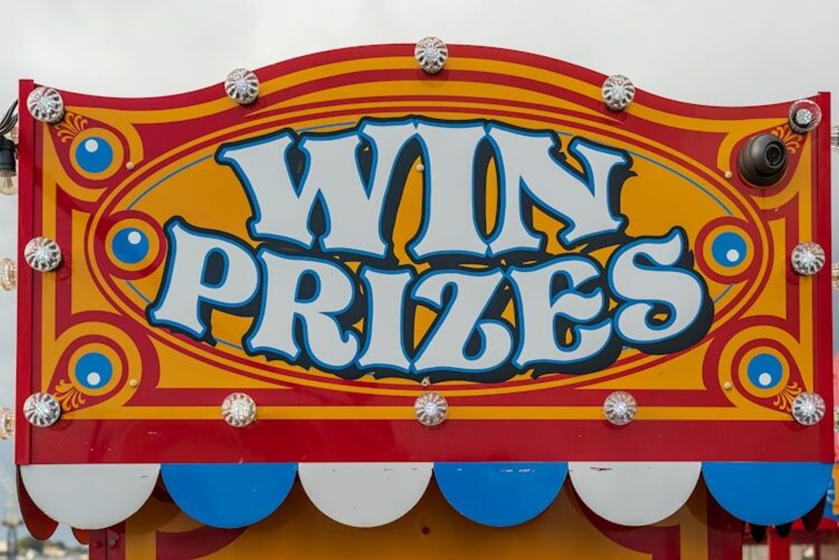 Carnival booth with a 'Win Prizes' sign