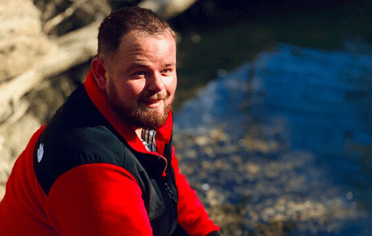 Man smiling near the water
