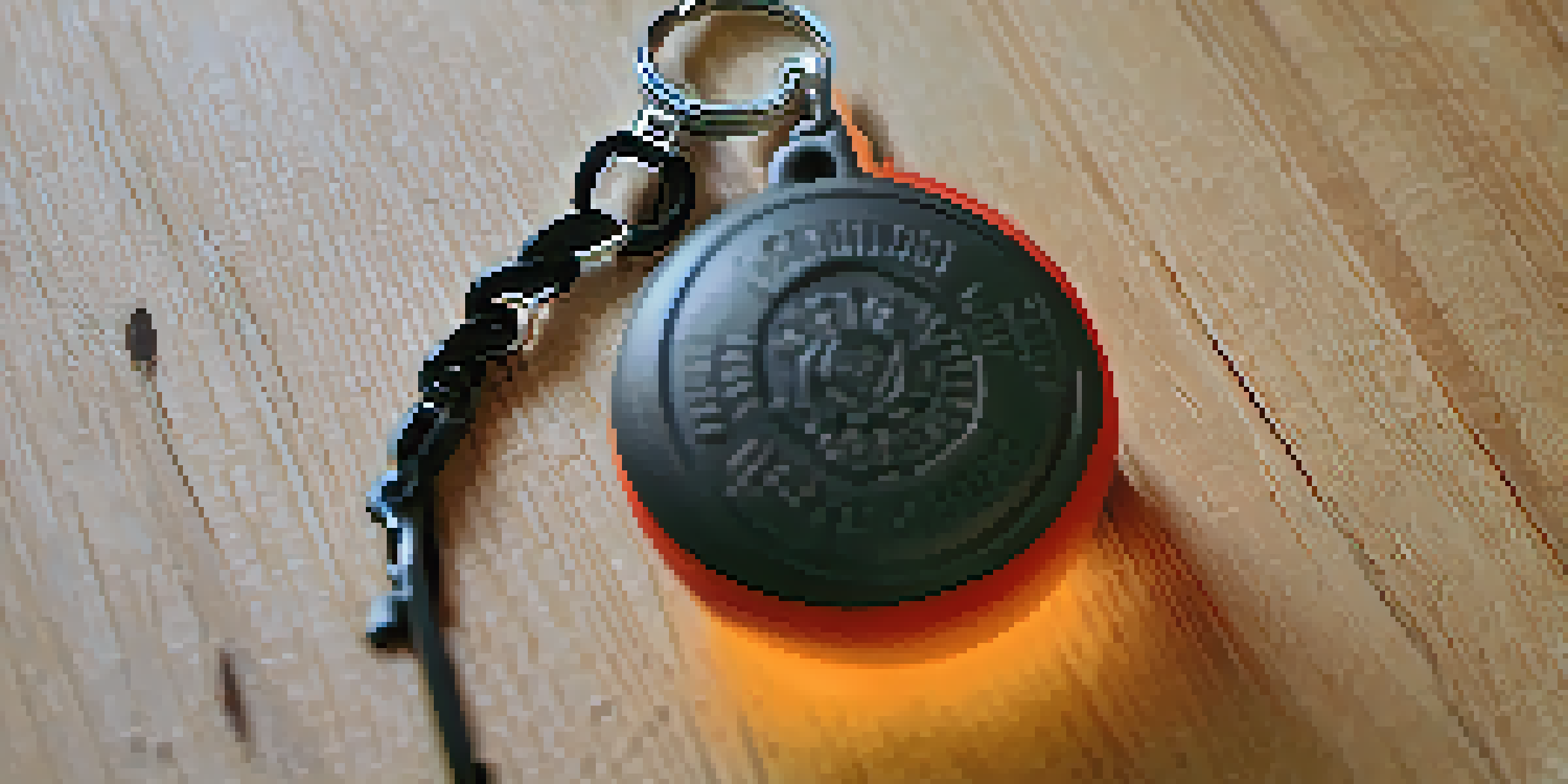 A close-up view of a DIY self-defense keychain with a hard rubber ball, resting on a wooden surface with soft lighting.