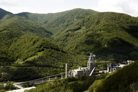 cement plant surrounded by green mountains