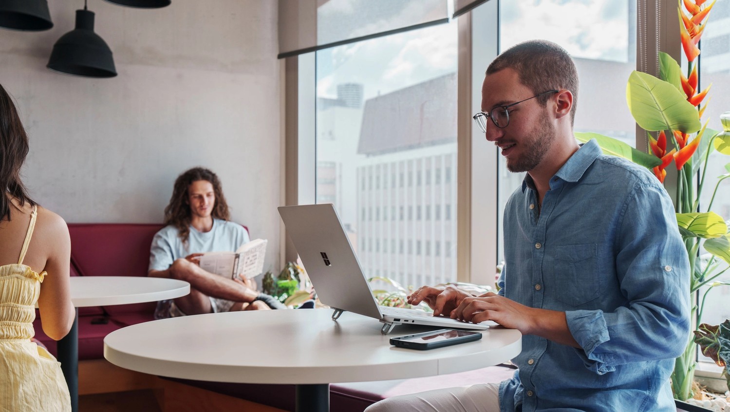 Light filled study area with students working at Student One