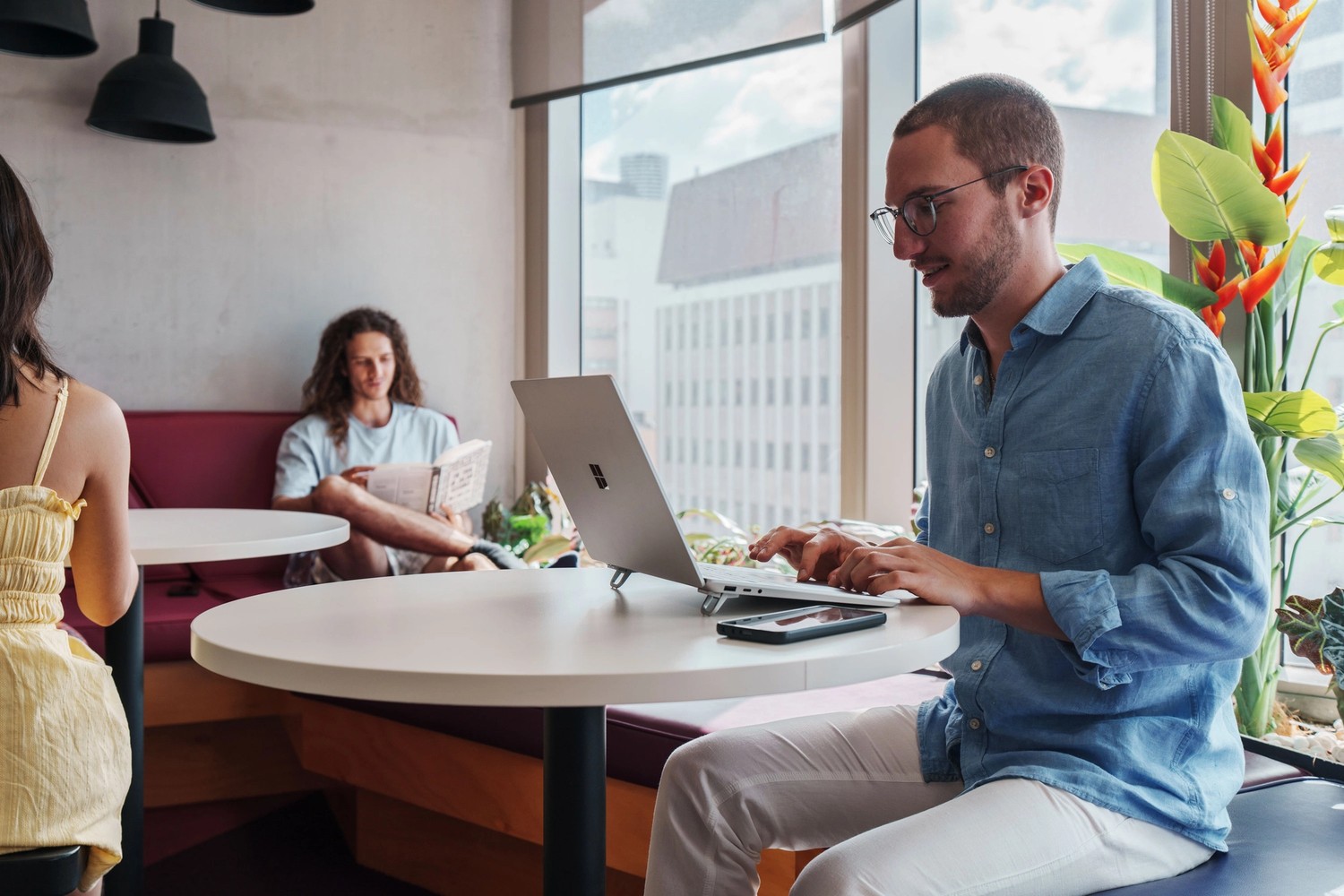 Light filled study area with students working at Student One