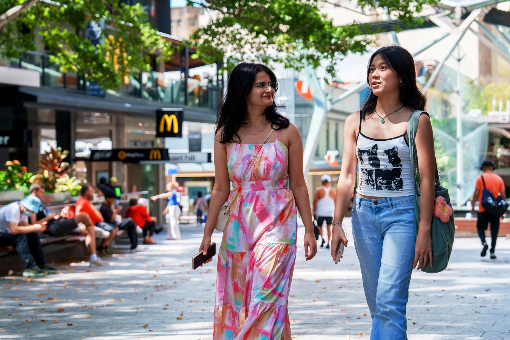 Two students walking through the Queen St Mall