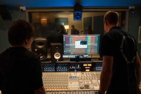 students standing over mixing desk
