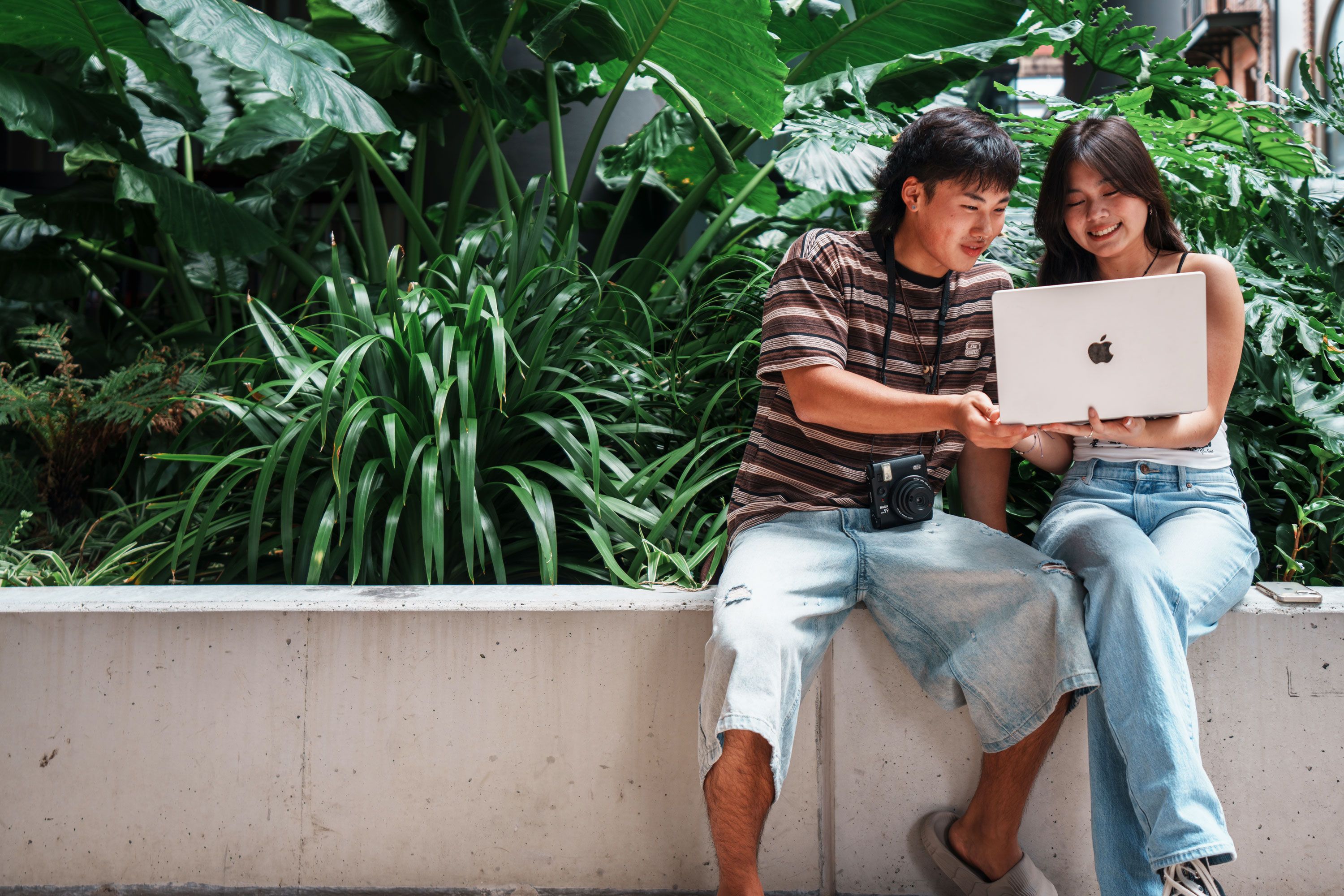 Under 18 International Students working on a laptop together