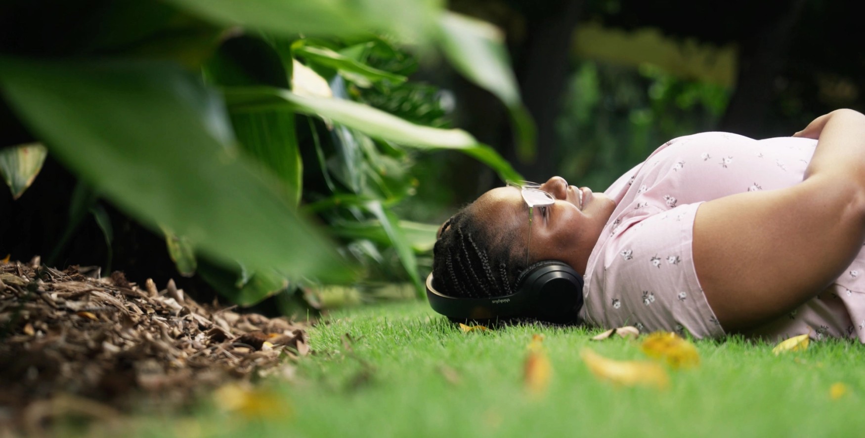Student lying on the grass and enjoying the sun in Brisbane's summer
