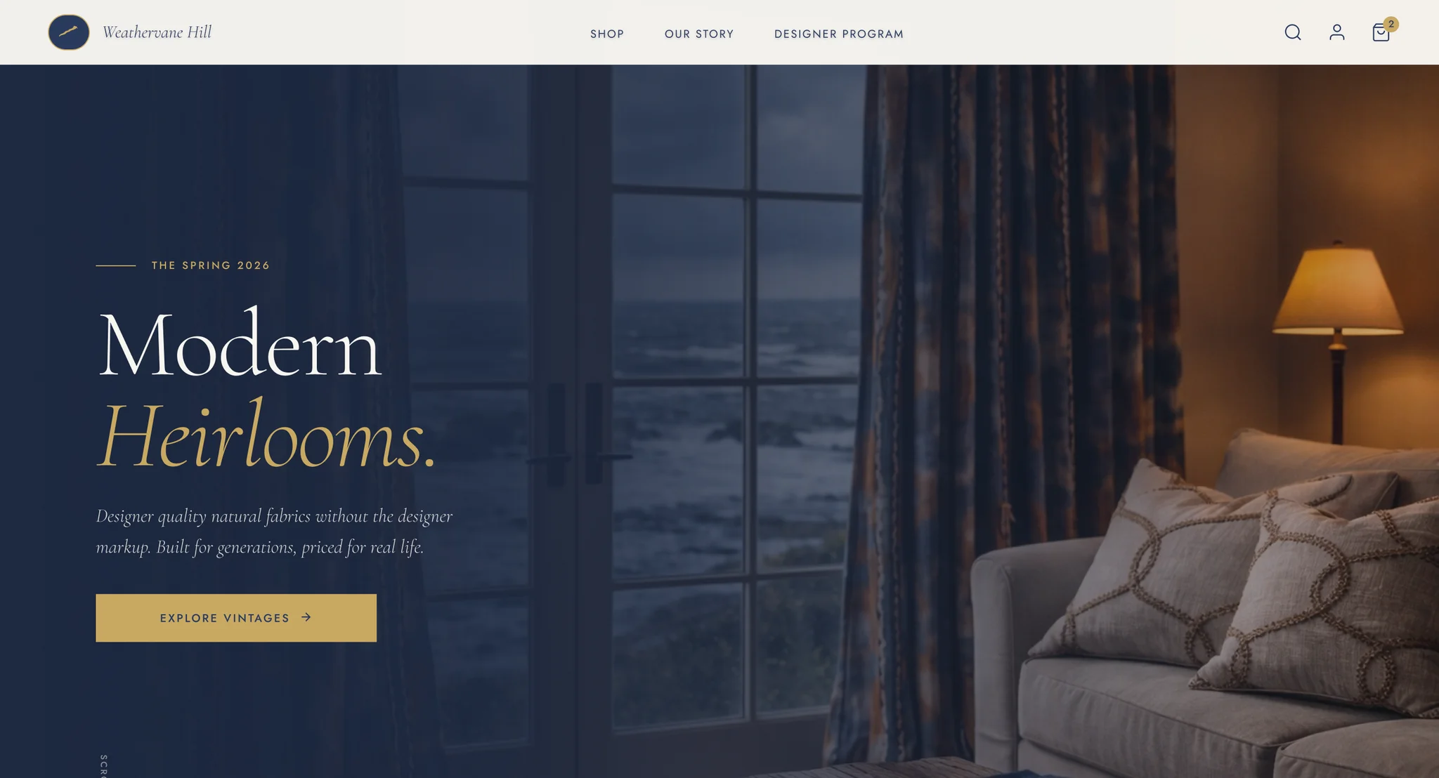 Alternate homepage design with a cream header and a dark living room at dusk, French windows onto a stormy sea, a lit floor lamp and a sofa, with "Modern Heirlooms." and a gold Explore Vintages button