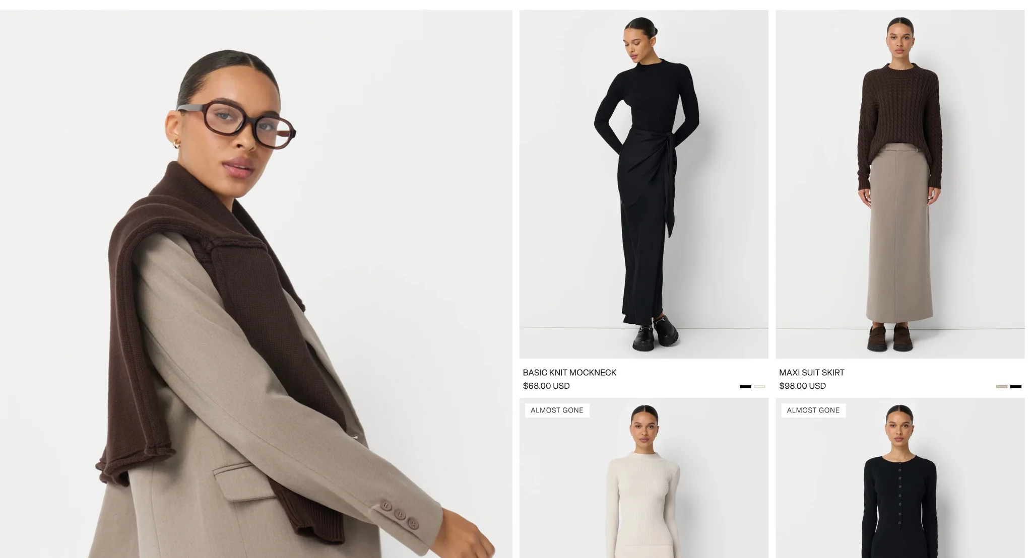 Homepage product row led by a large photo of a model in brown glasses with a brown knit over a taupe blazer, beside cards for the Basic Knit Mockneck and the Maxi Suit Skirt and two more cards marked Almost gone