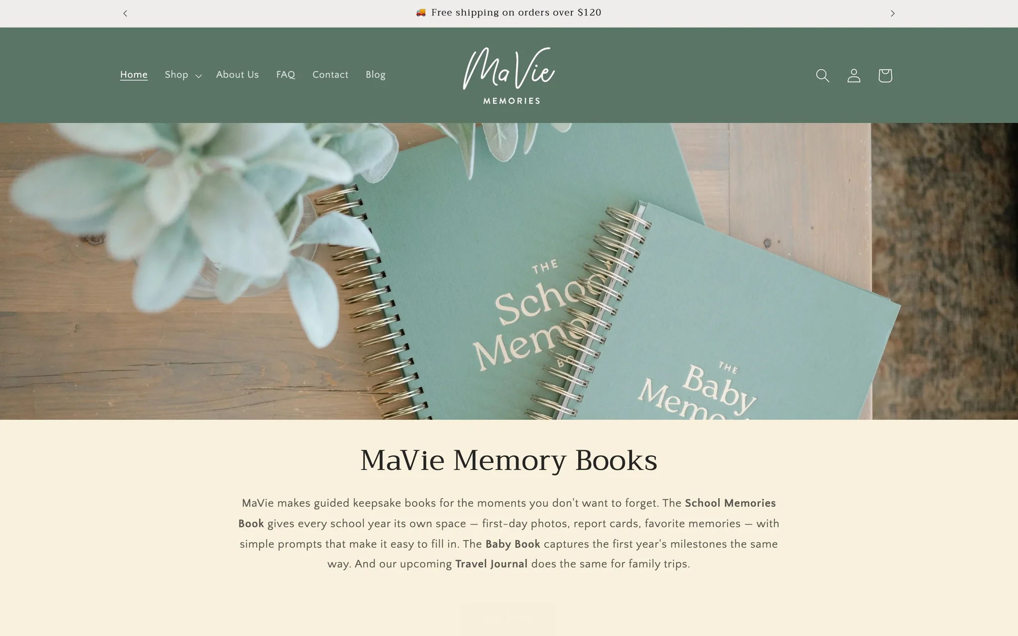 Mavie Memories homepage with sage-green header, script logo and School and Baby Memories books on a wooden table.
