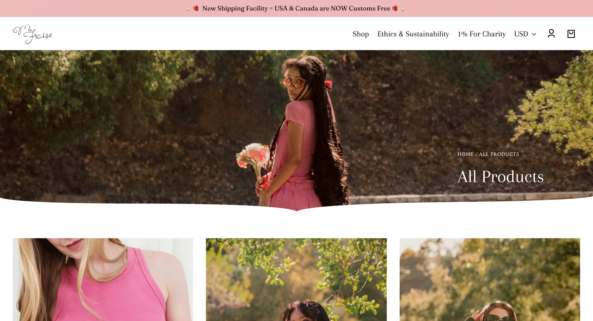 All Products collection page with a photo banner of a model in the pink set holding flowers and looking back over her shoulder, the title and breadcrumb on the right and a curved lower edge
