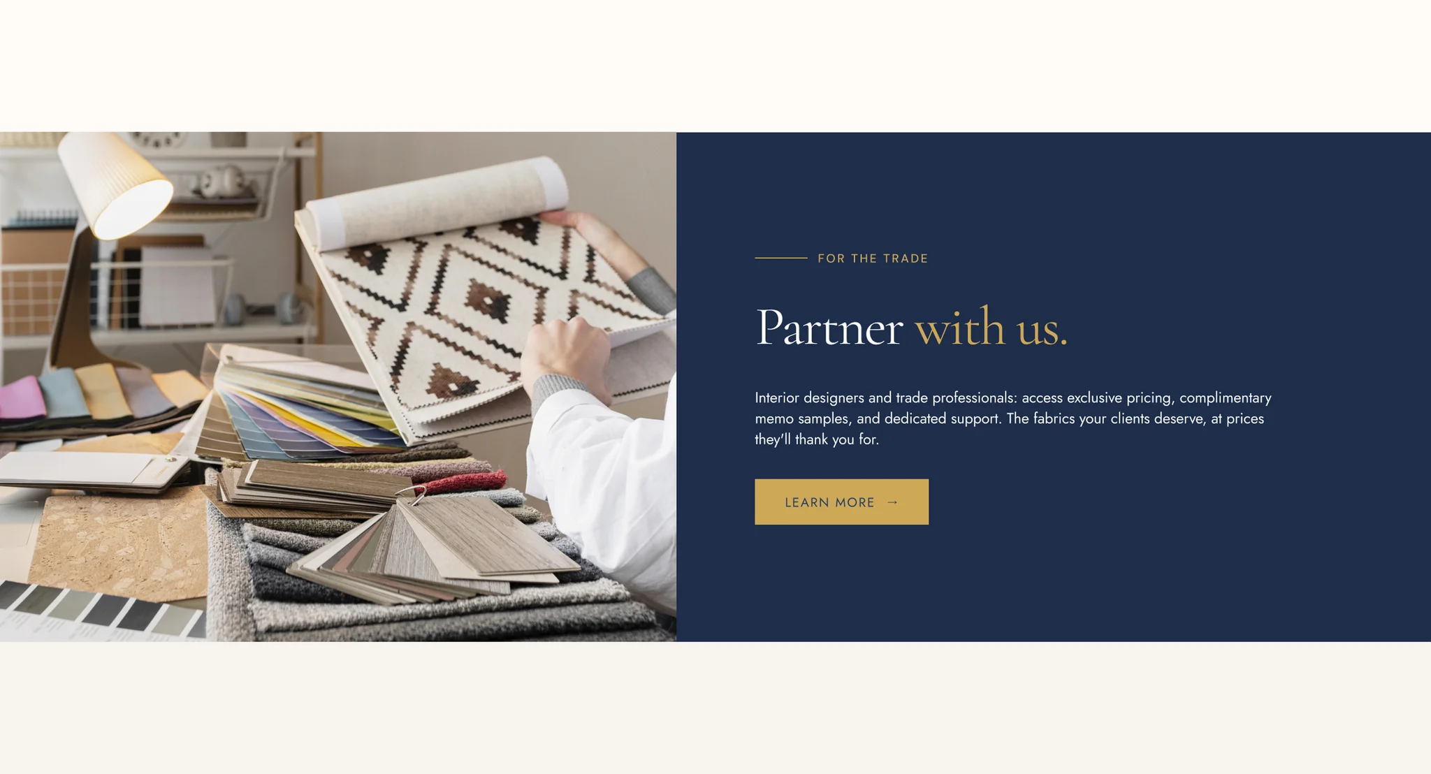 Trade banner design: a designer's desk with fabric swatch books beside a navy panel reading "Partner with us." for interior designers and trade professionals, with a gold Learn More button