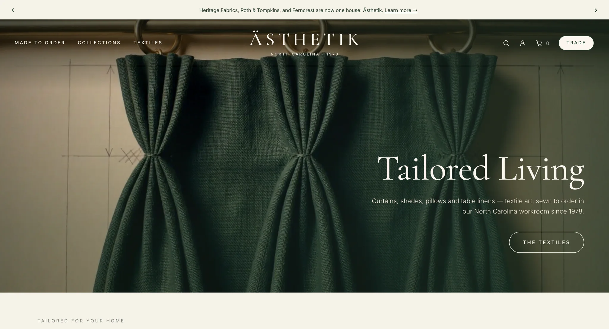 Ästhetik homepage hero: dark green linen drapery on ring tops, the headline "Tailored Living" and a "The Textiles" button