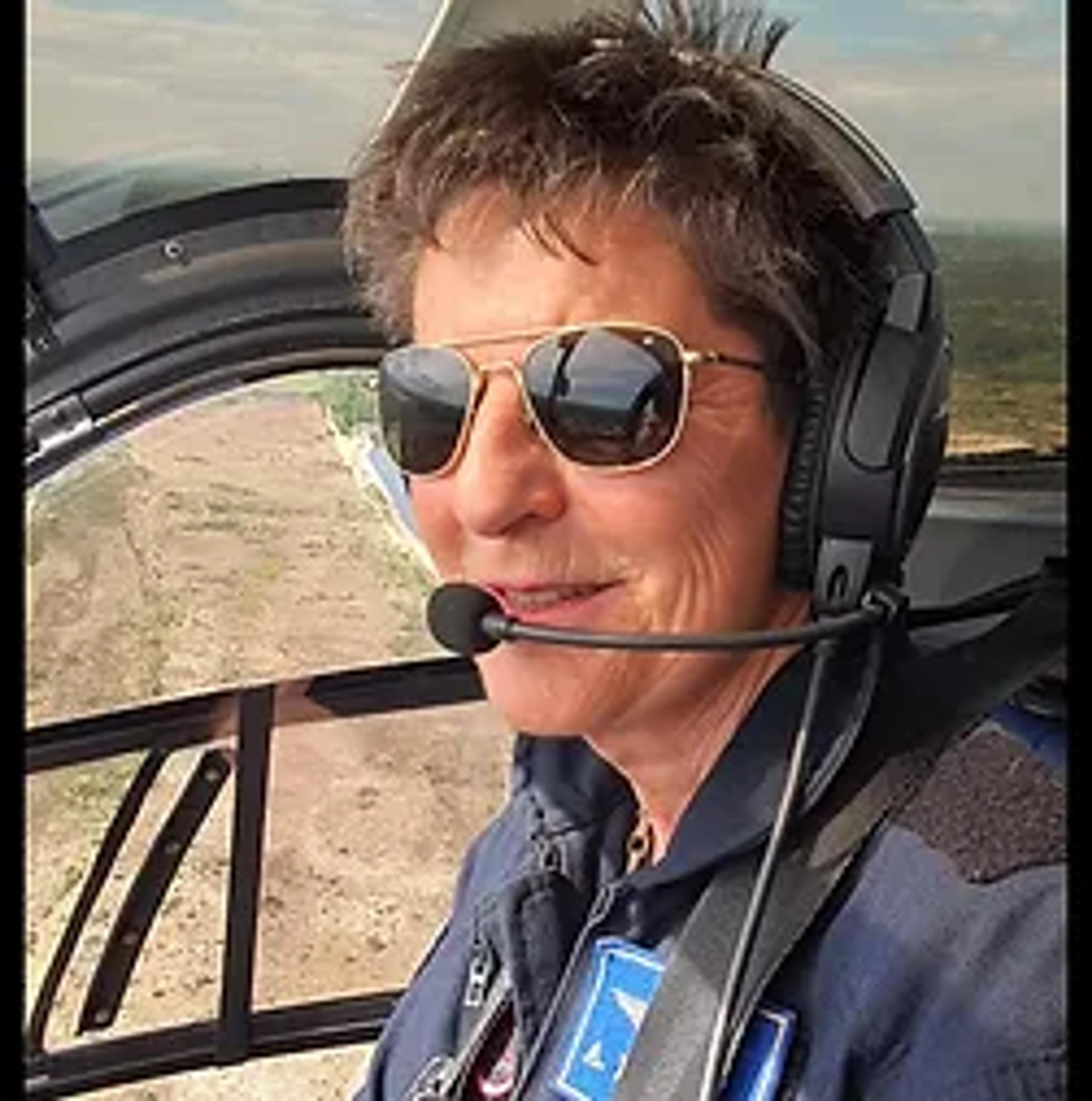 Dr Ann Lechat wearing a headset in a helicopter cockpit