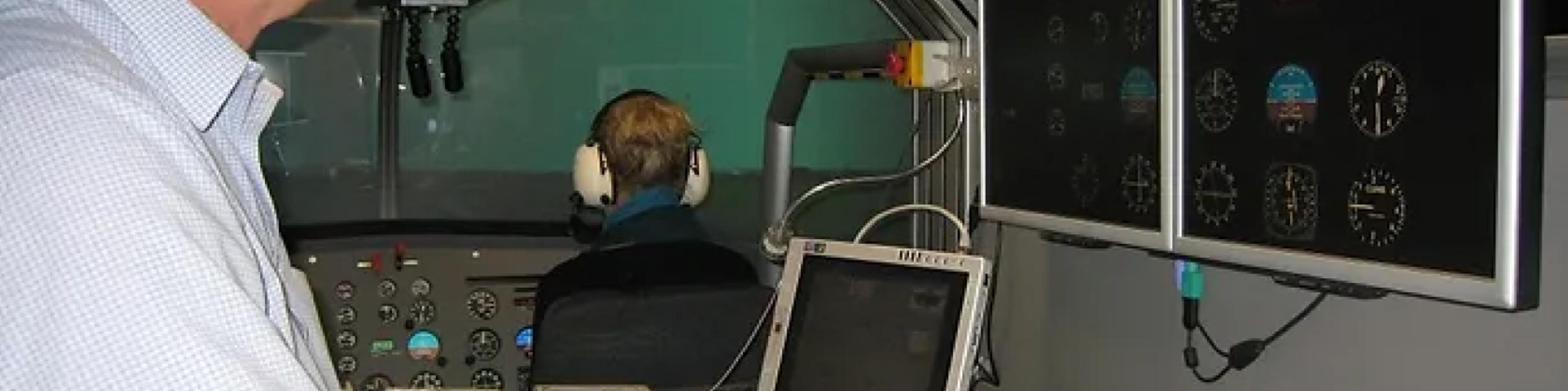 Instructor at the FNPT II helicopter simulator control station