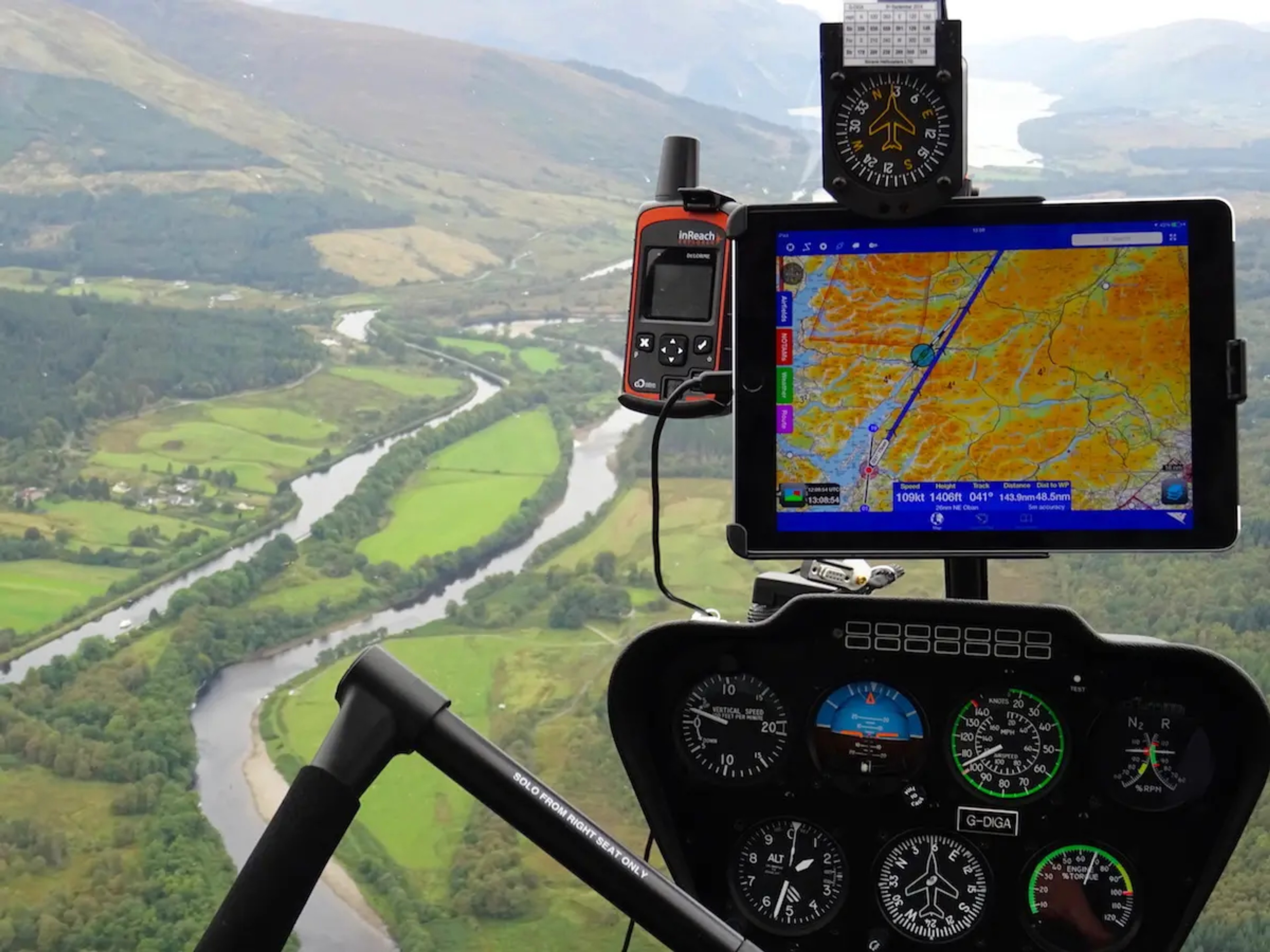 Helicopter cockpit moving map while flying over a river valley