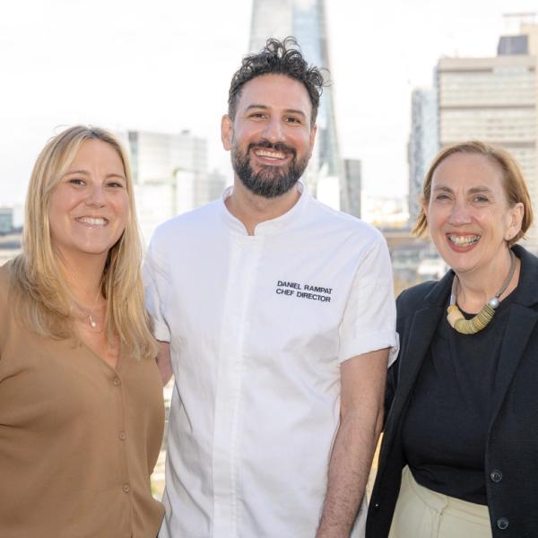 Three people smiling and posing for the camera
