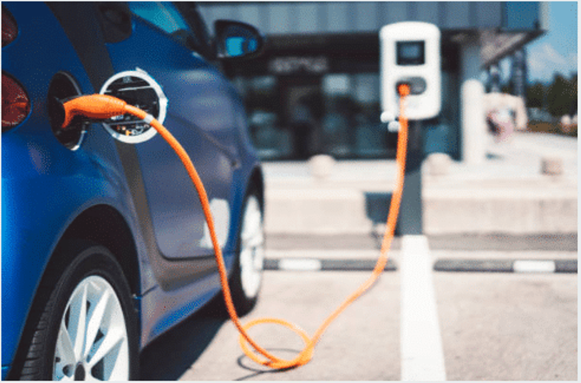 Voiture électrique bleue en cours de recharge sur une borne publique
