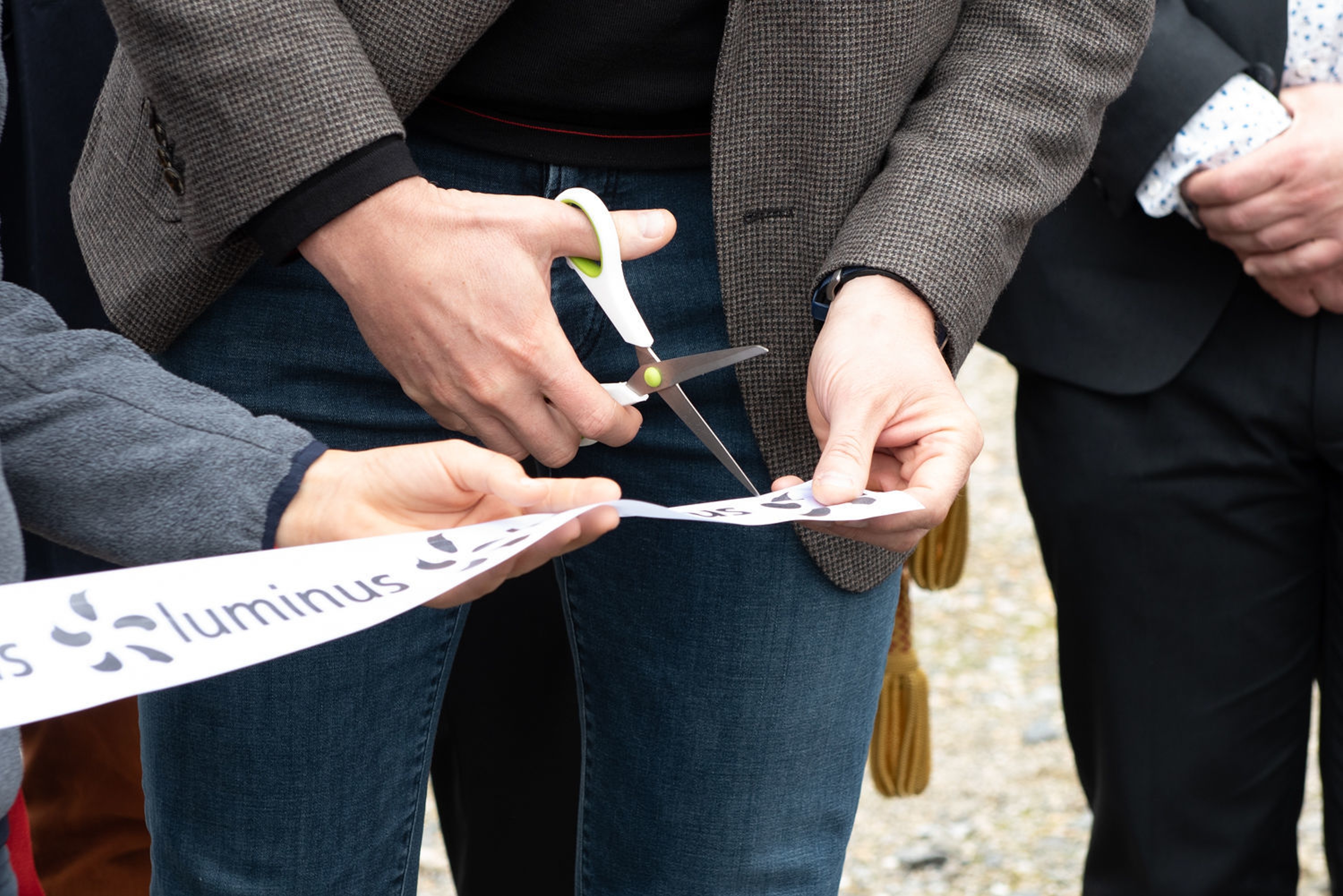 couple qui court en tenant un enfant par la main, devant une maison avec des panneaux solaires