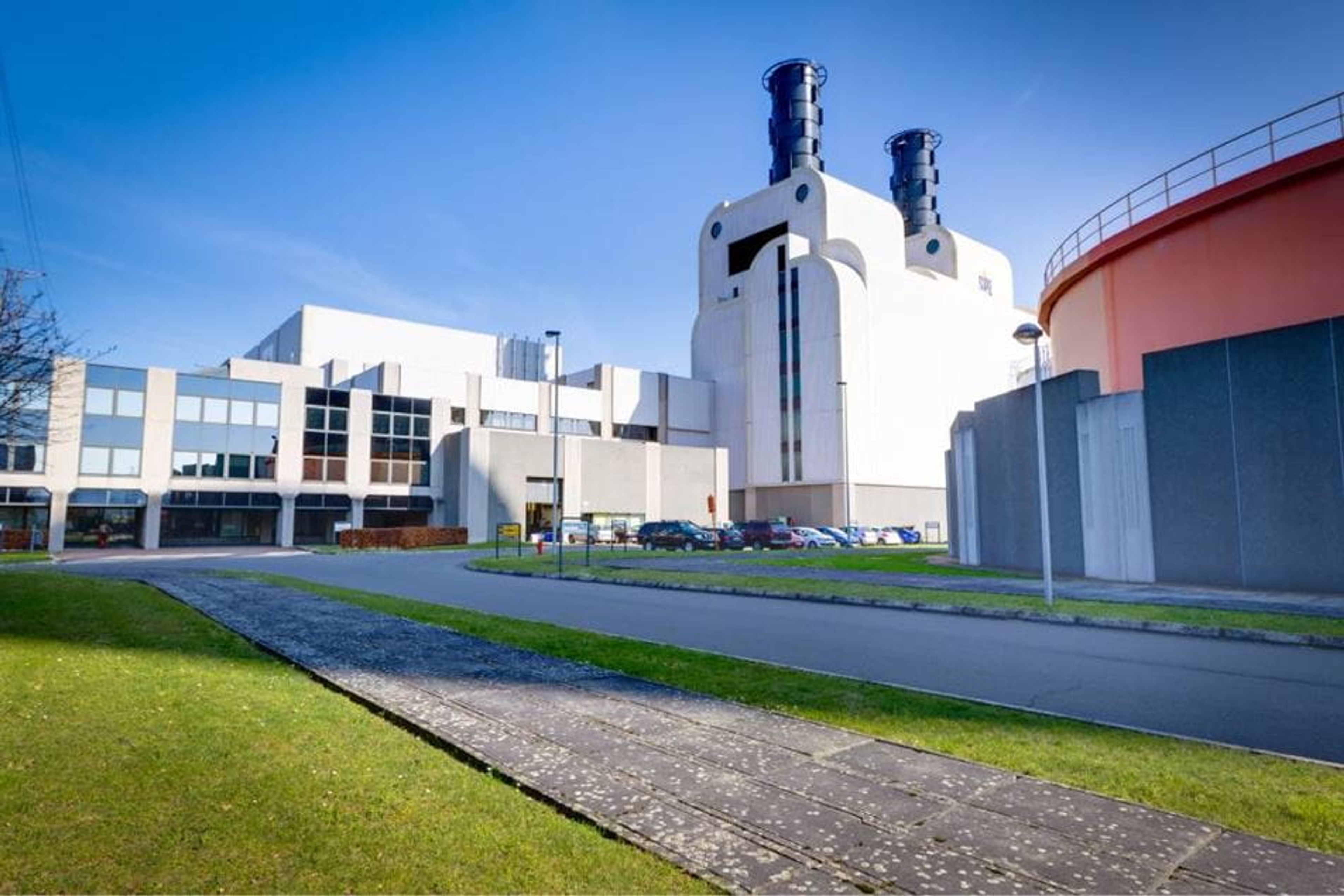 Vue extérieure de la centrale gaz-vapeur, avec ses grands bâtiments blancs