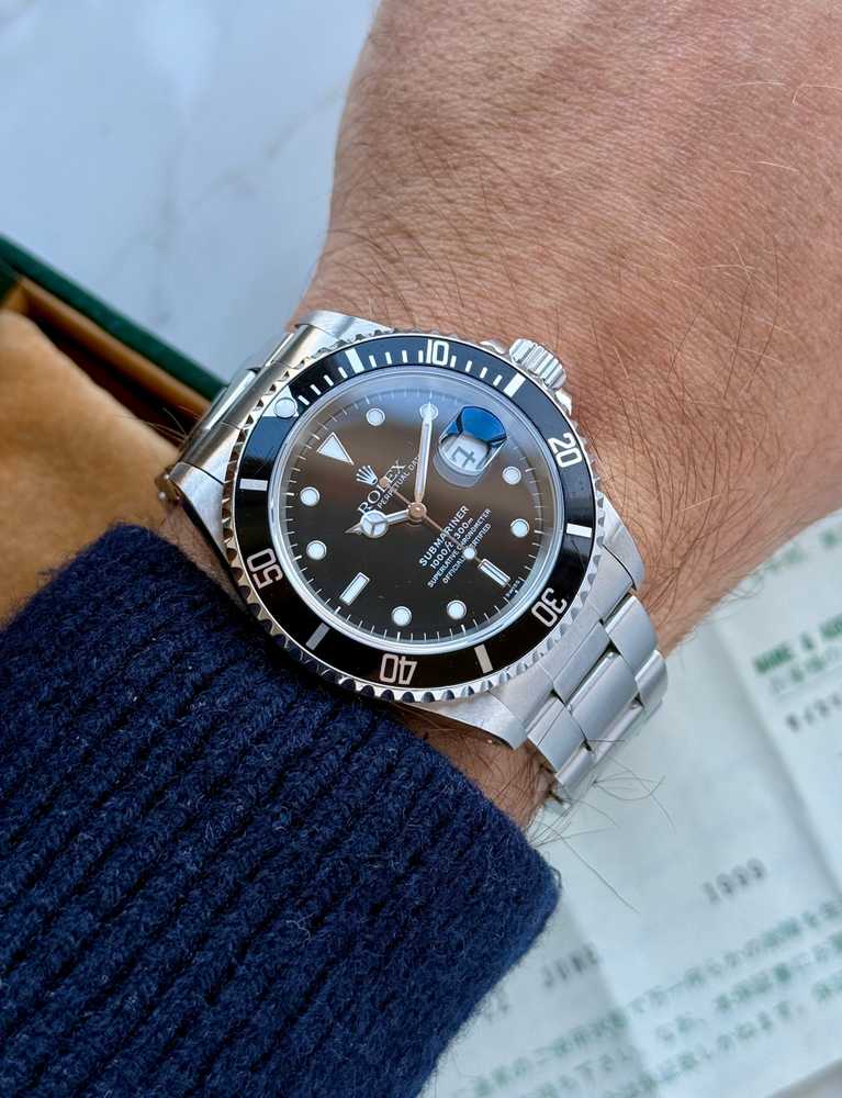 Wrist shot image for Rolex Submariner "Swiss" 16610 Black 1999 with original box and papers 2