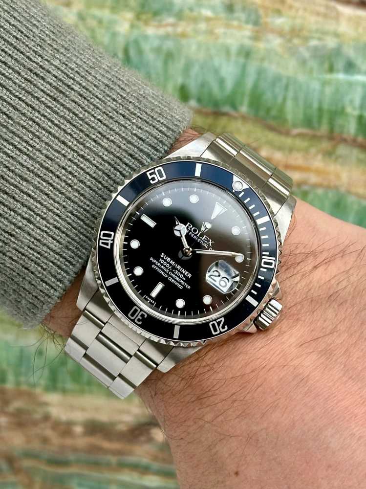 Wrist shot image for Rolex Submariner "Swiss" 16610T Black 1999 with original box and papers