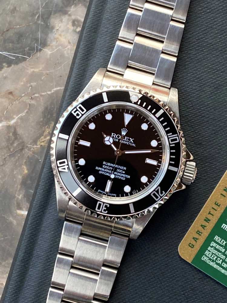 Featured image for Rolex Submariner "engraved rehaut" 14060M Black 2009 with original box and papers