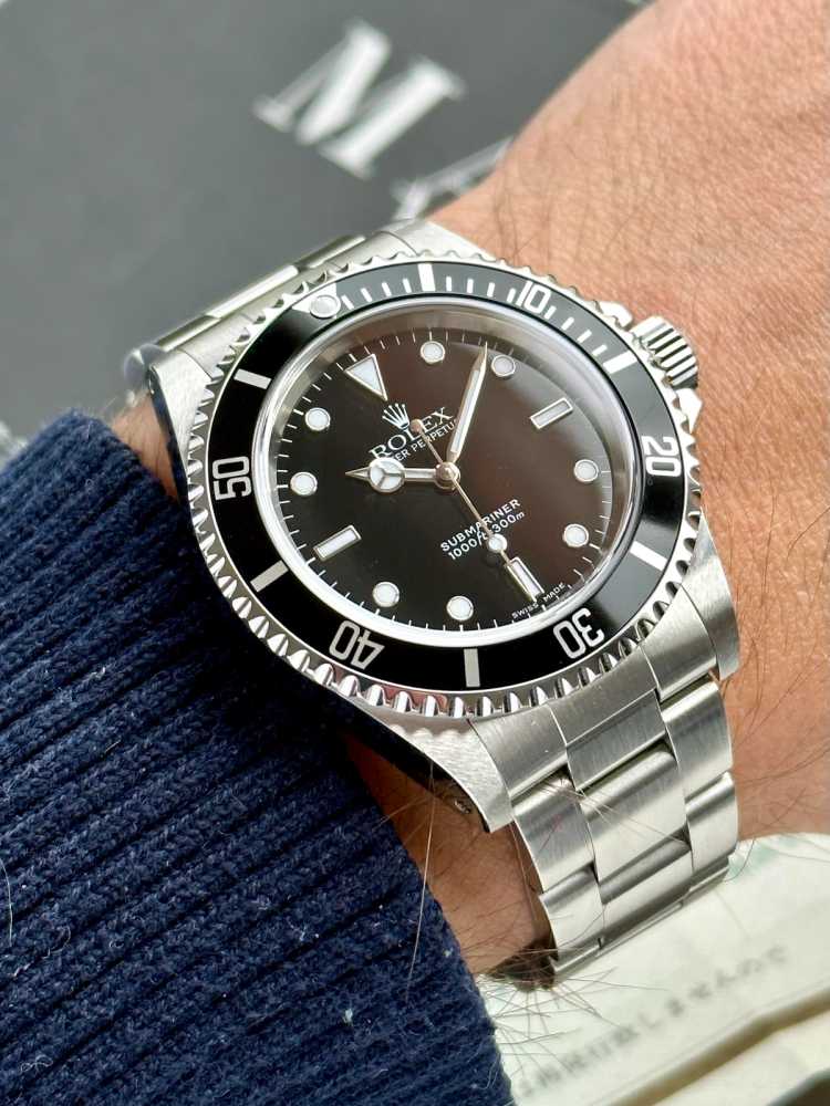 Wrist image for Rolex Submariner 14060 Black 2000 with original box and papers 3