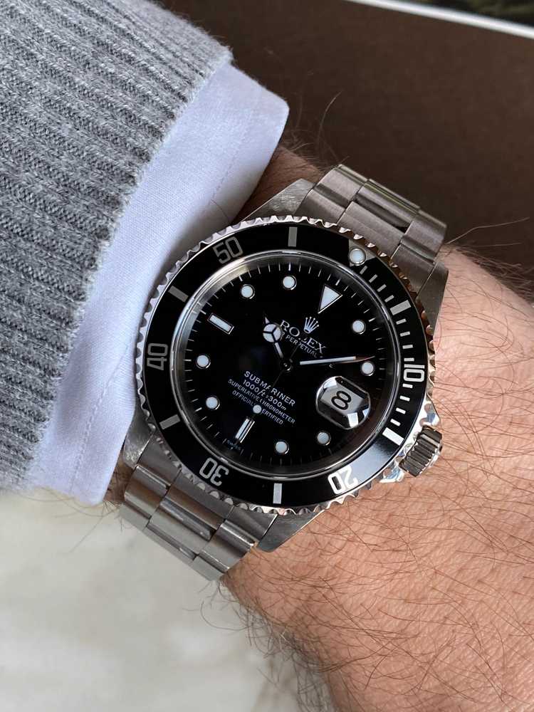 Wrist shot image for Rolex Submariner "Swiss" 16610 Black 1999 with original box and papers