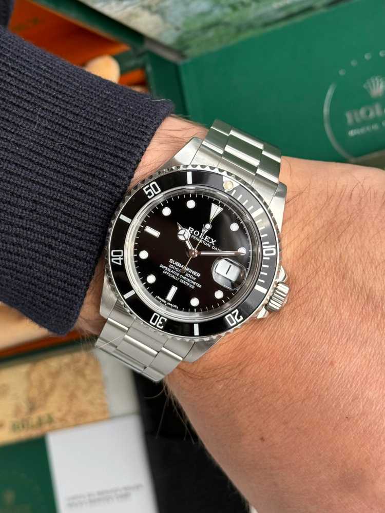 Wrist image for Rolex Submariner "Rolex Warranty" 16610 Black 1989 with original box and papers