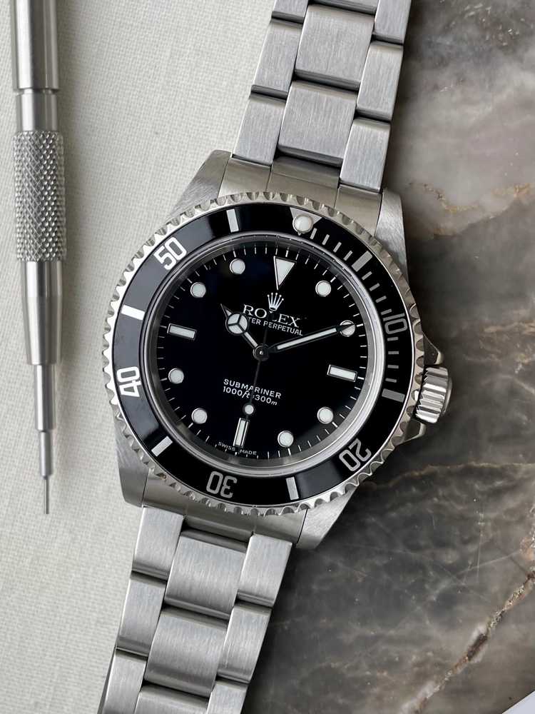 Current image for Rolex Submariner 14060 Black 2000 with original box and papers 2