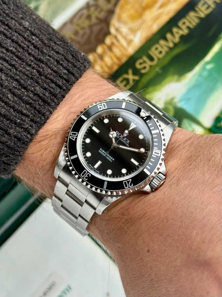 Wrist shot image for Rolex Submariner 14060 Black 1993 with original box and papers 2