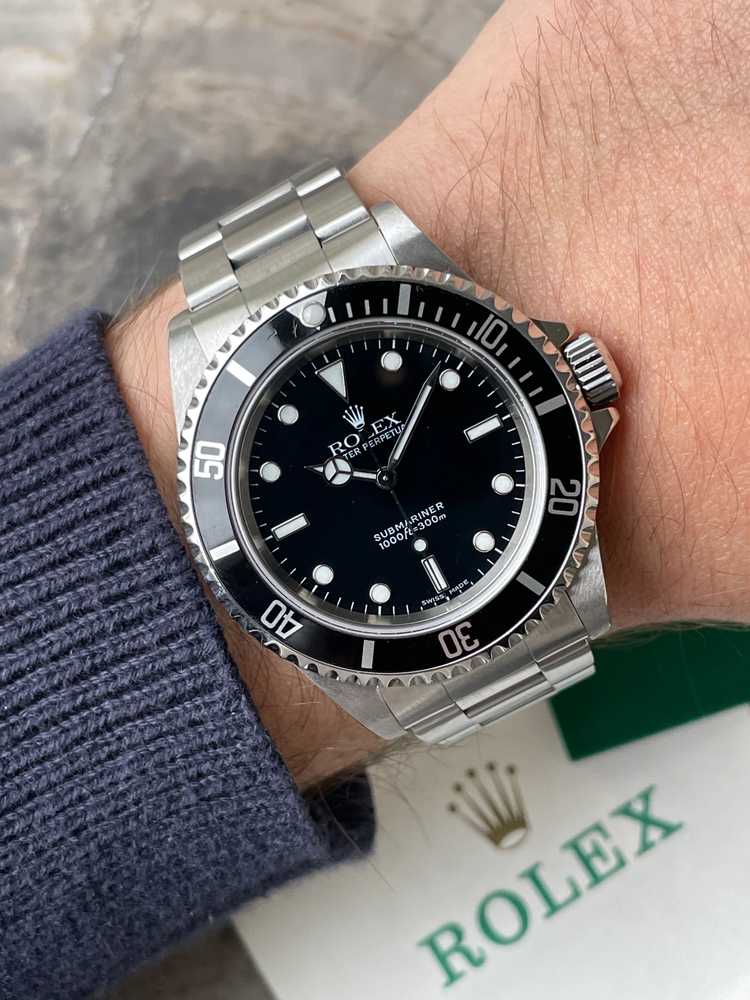 Wrist image for Rolex Submariner 14060 Black 2000 with original box and papers 2