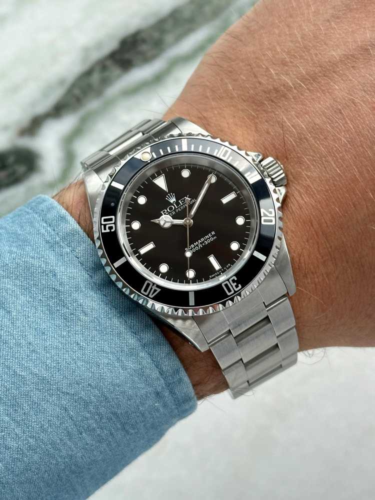 Wrist shot image for Rolex Submariner 14060 Black 1991 with original box and papers